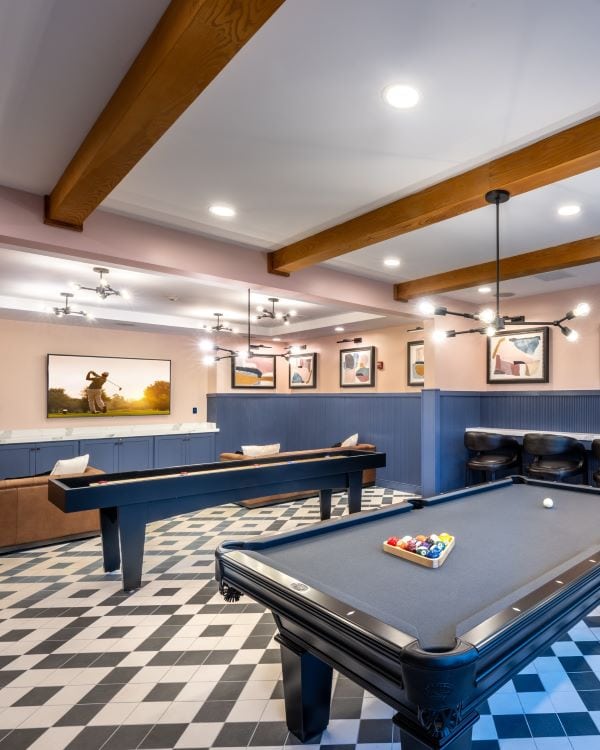 Three friends laugh around a grill on a summer afternoon